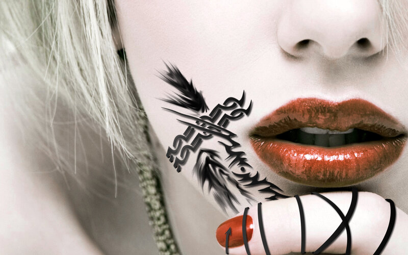 woman with red lips and tattoo