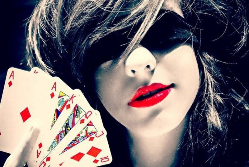 woman with red lips holding cards