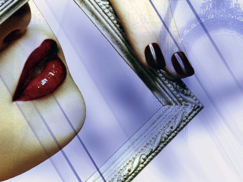woman with red lips holding mirror