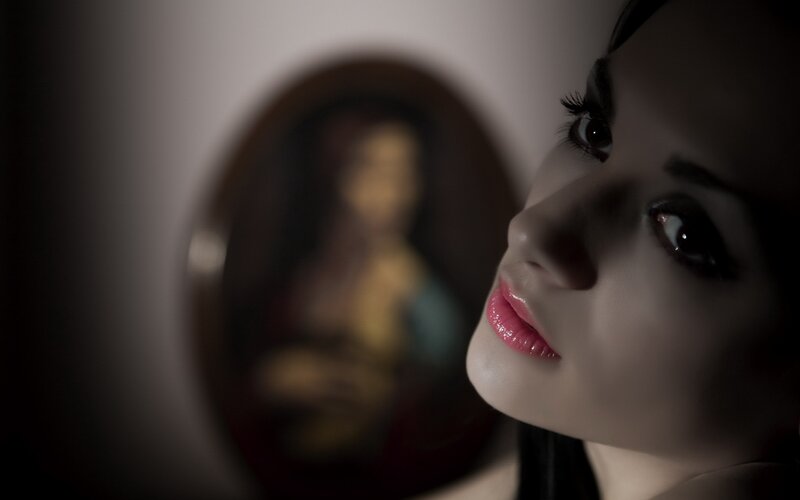 woman with red lips in dim light