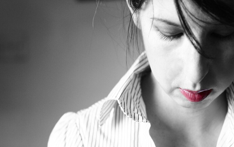 woman with red lips looking down