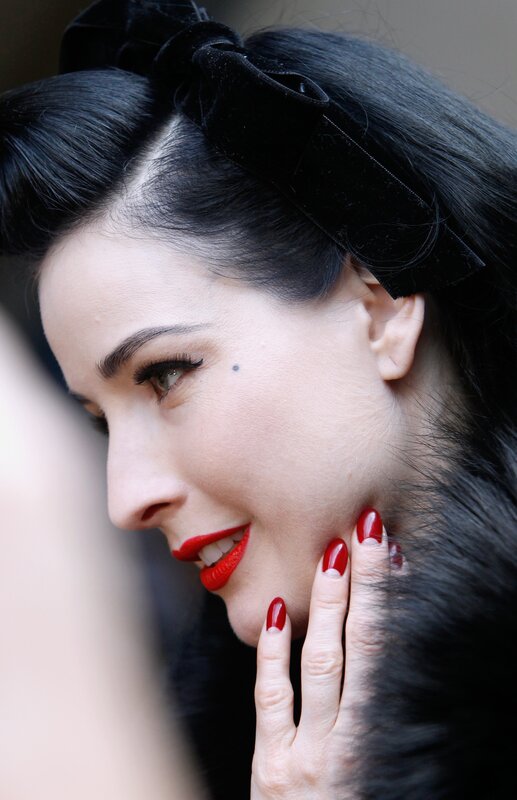 woman with red lipstick and black bow