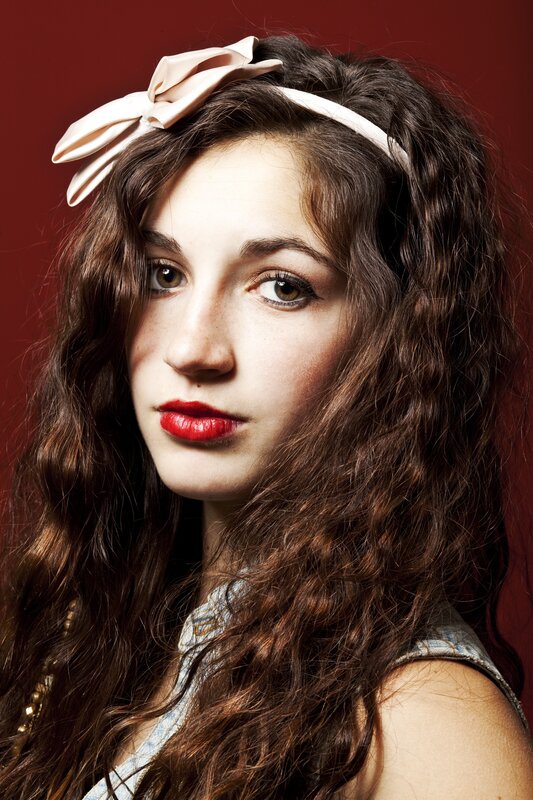woman with red lipstick and bow