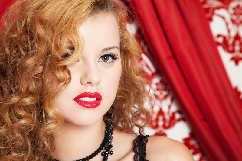 woman with red lipstick and curly hair