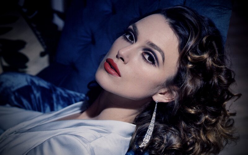 woman with red lipstick and earrings