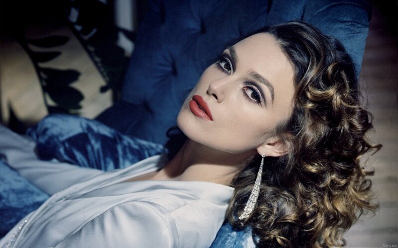 woman with red lipstick and earrings