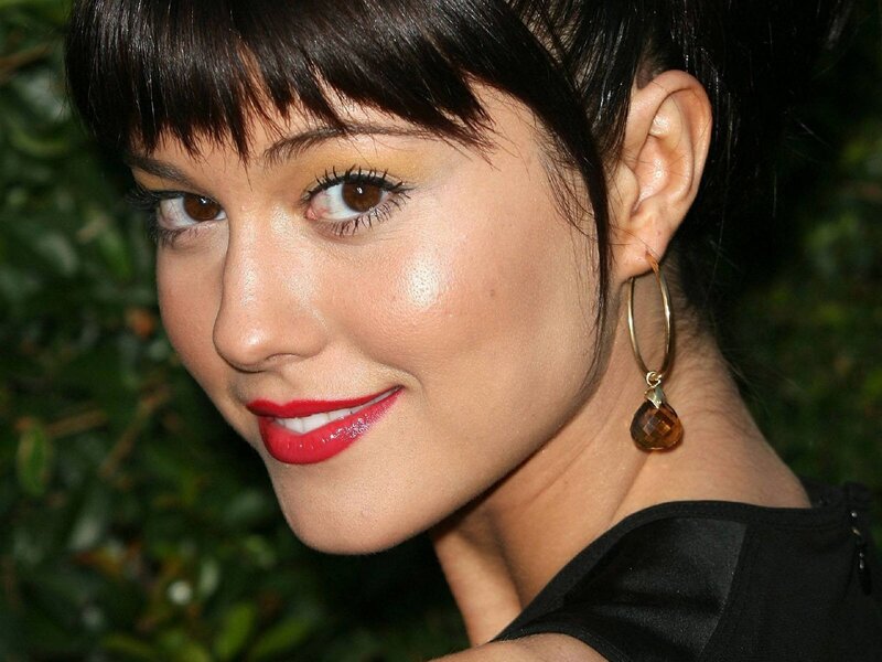 woman with red lipstick and earrings