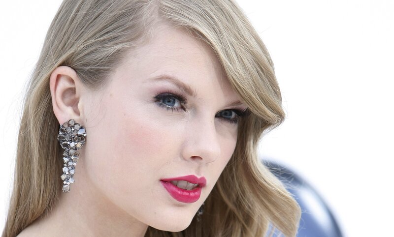 woman with red lipstick and earrings