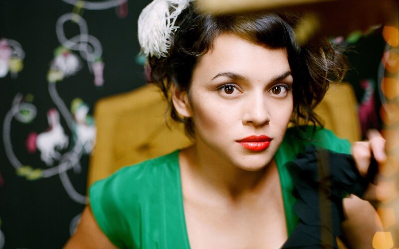 woman with red lipstick and feather