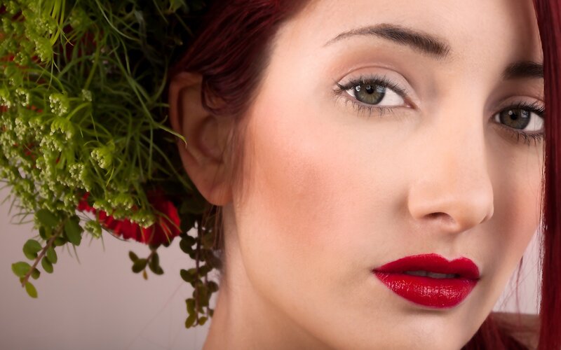 woman with red lipstick and flowers