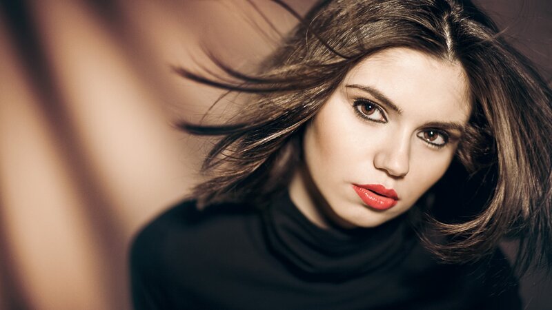 woman with red lipstick and flowing hair