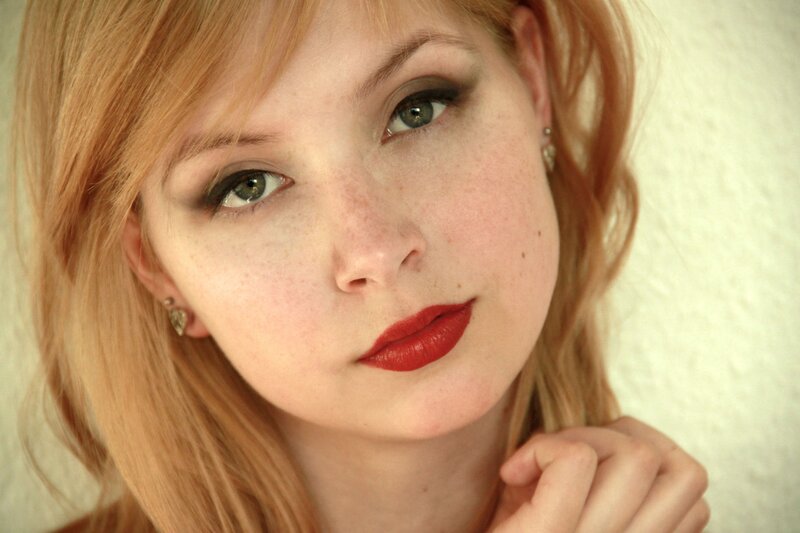 woman with red lipstick and freckles