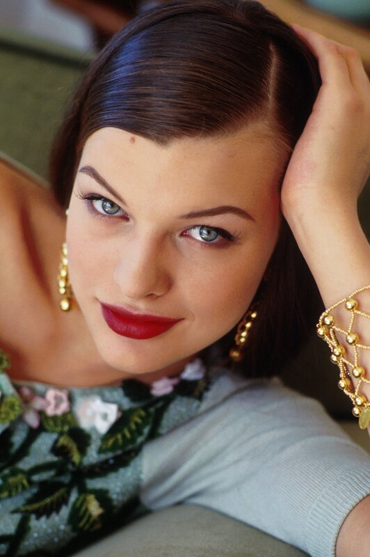 woman with red lipstick and gold jewelry