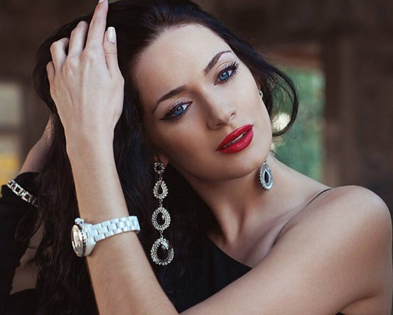 woman with red lipstick and jewelry