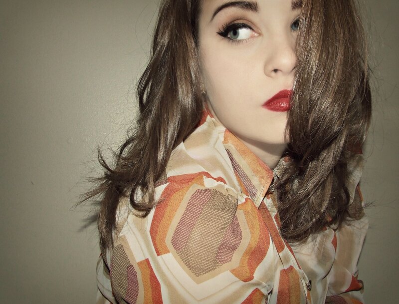 woman with red lipstick and patterned shirt