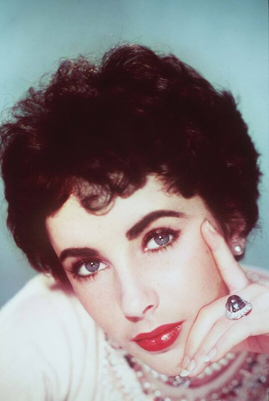 woman with red lipstick and pearls