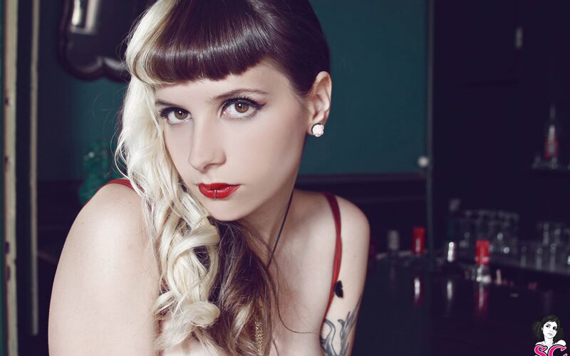 woman with red lipstick and tattoos
