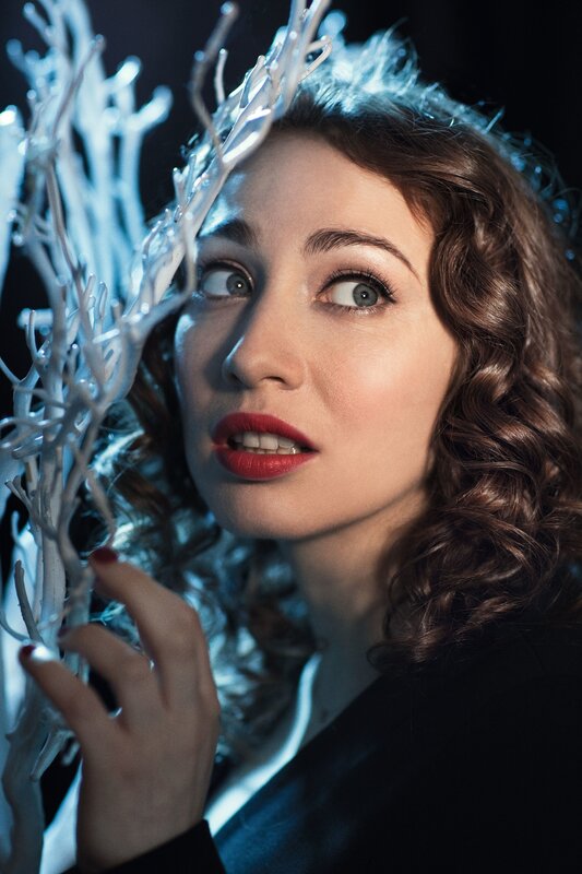 woman with red lipstick and white branches