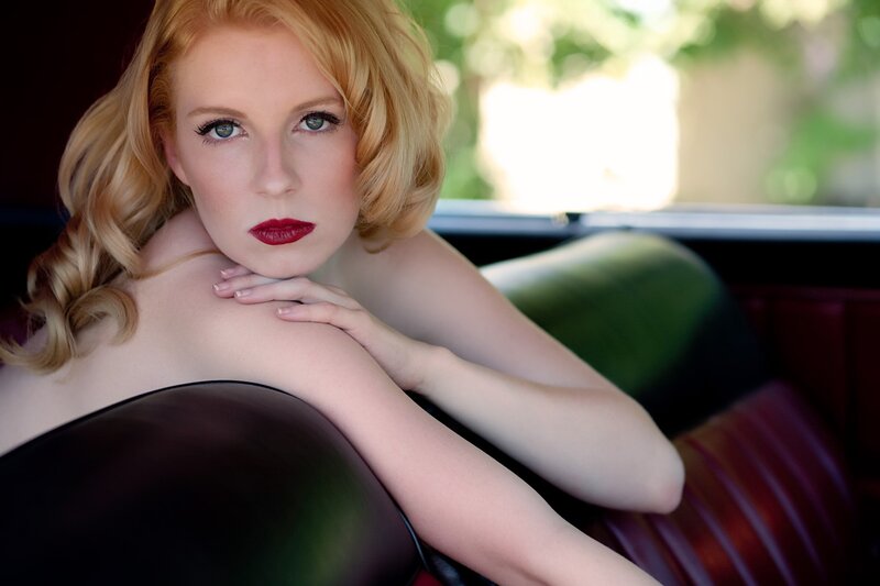 woman with red lipstick in car