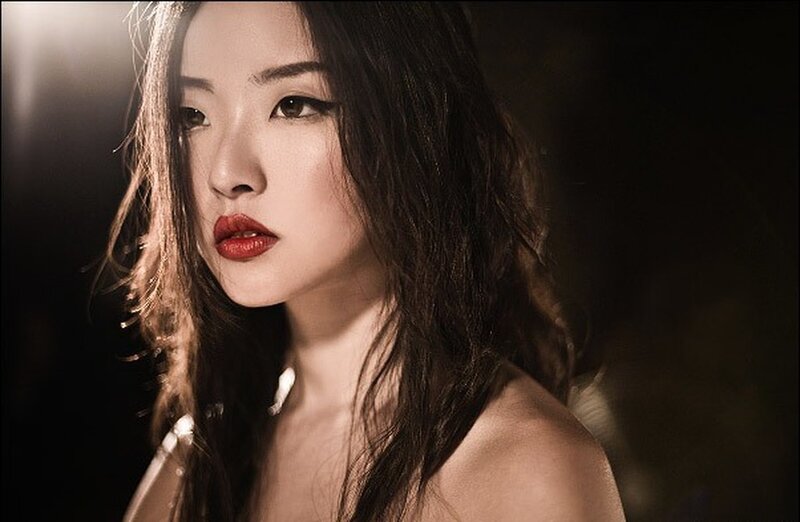 woman with red lipstick in dim light