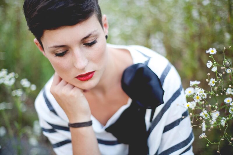 woman with red lipstick in field