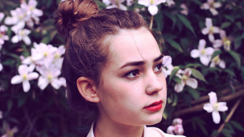woman with red lipstick in garden