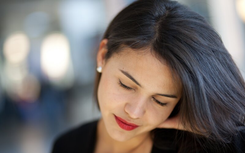 woman with red lipstick looking down