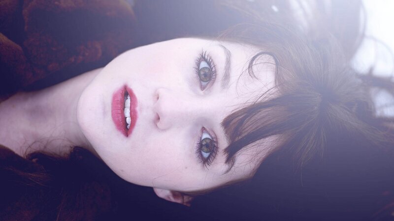 woman with red lipstick looking up
