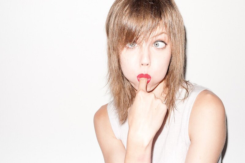 woman with red lipstick making a face