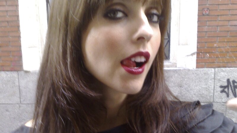 woman with red lipstick speaking