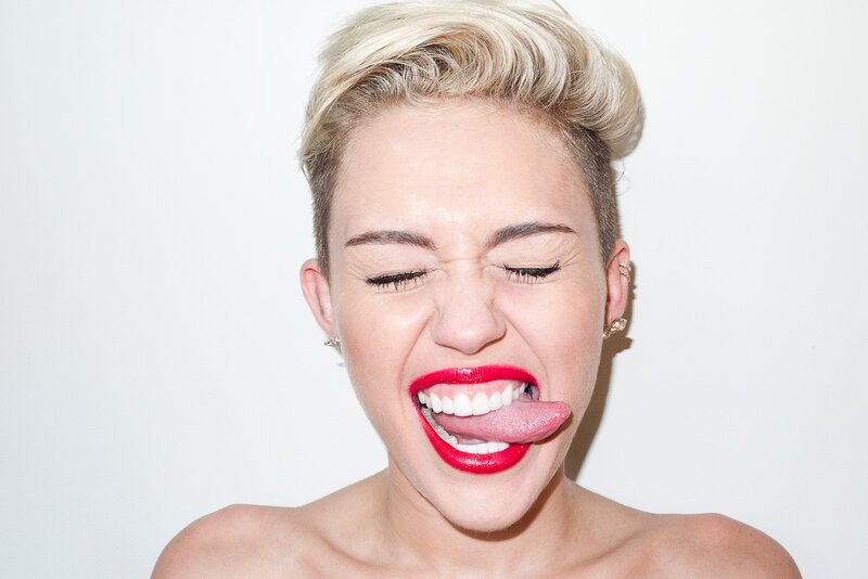 woman with red lipstick sticking out tongue