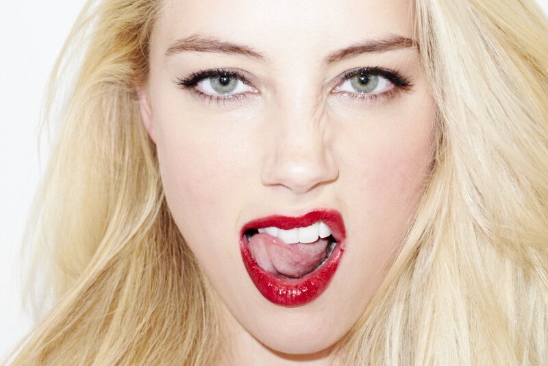 woman with red lipstick sticking out tongue