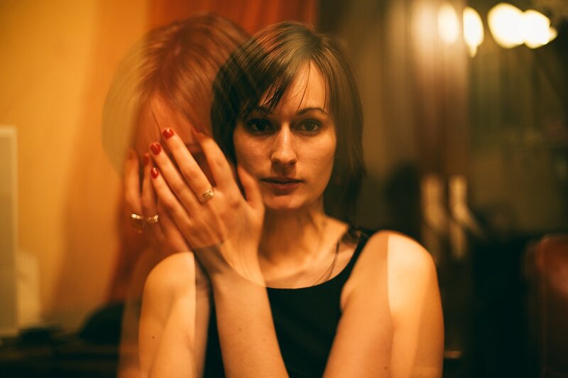 woman with red nails and black top
