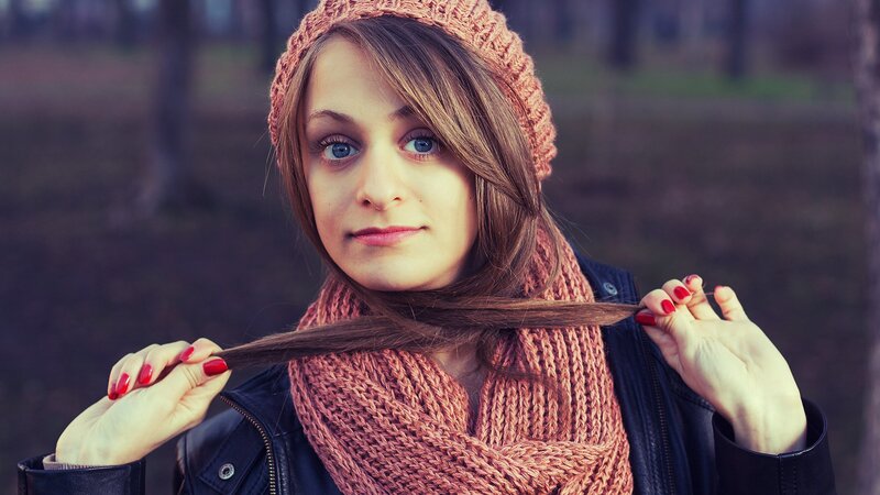 woman with red nails and scarf