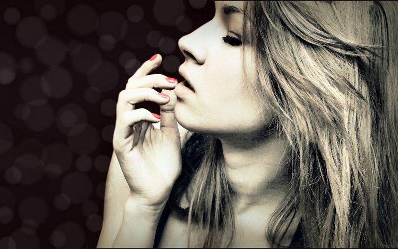 woman with red nails in profile