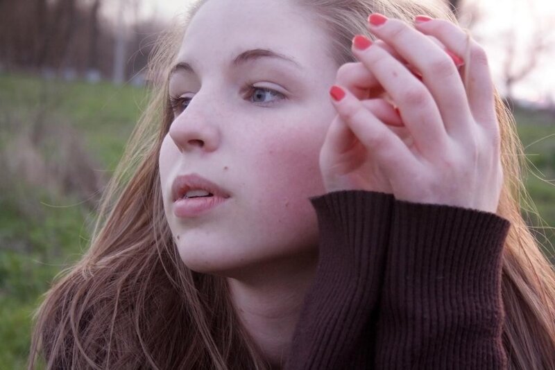 woman with red nails outdoors