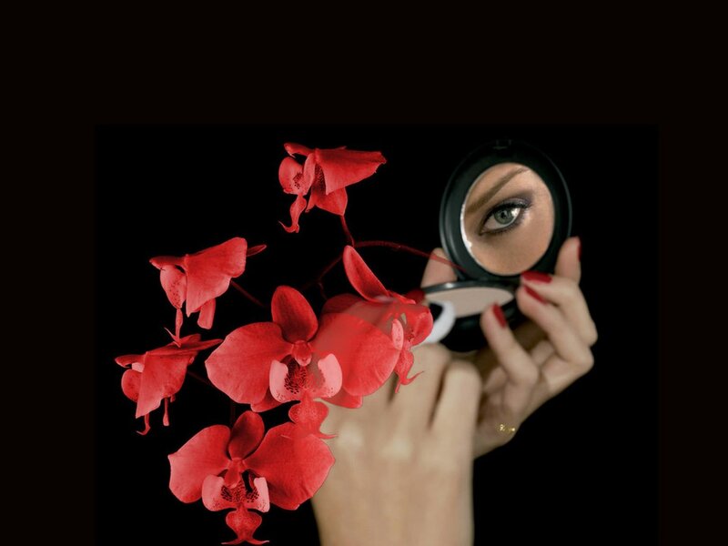 woman with red orchids and mirror