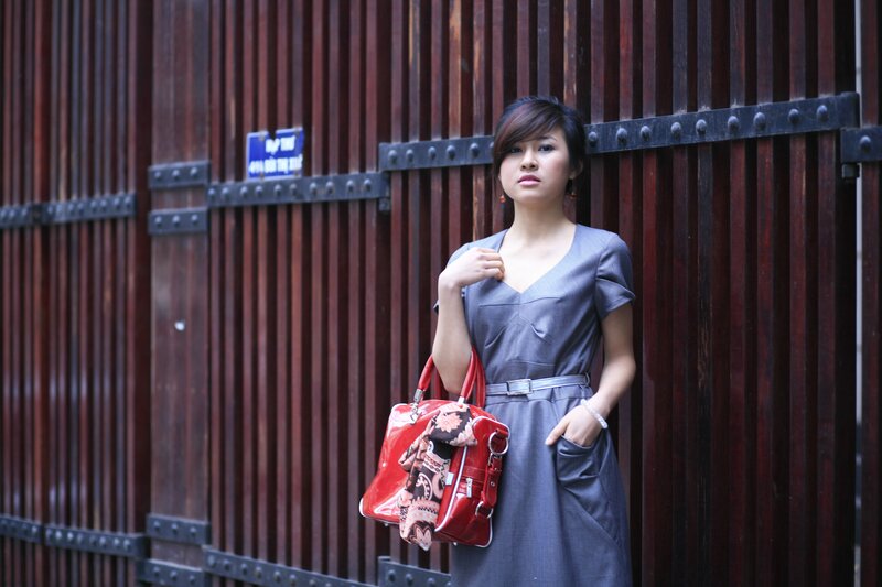woman with red purse standing
