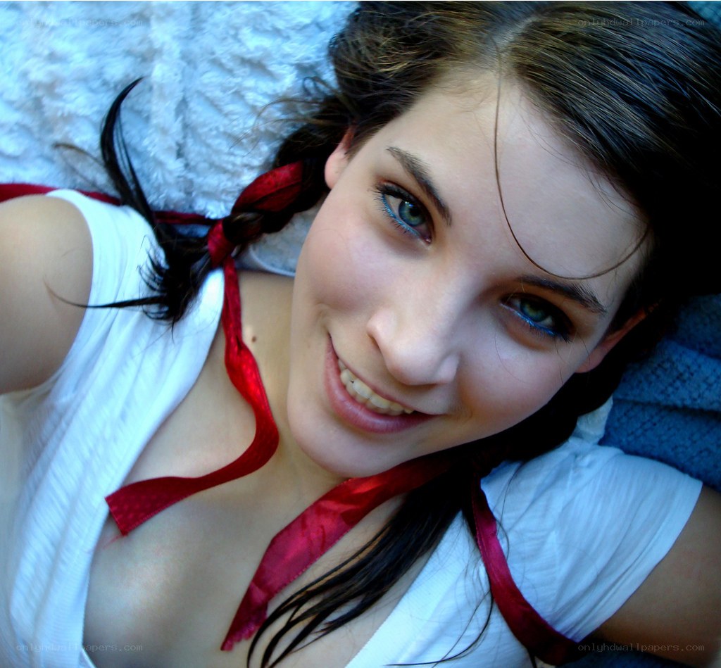 woman with red ribbon smiling