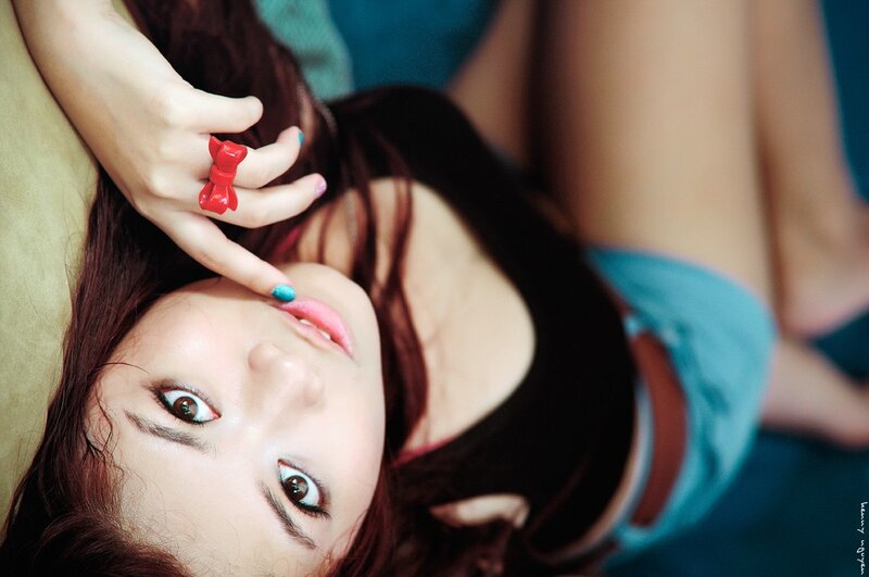 woman with red ring lying down