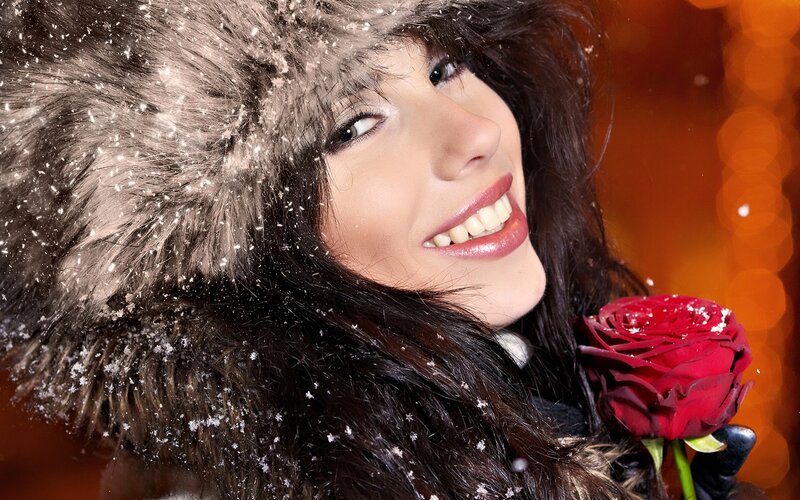 woman with red rose in snow