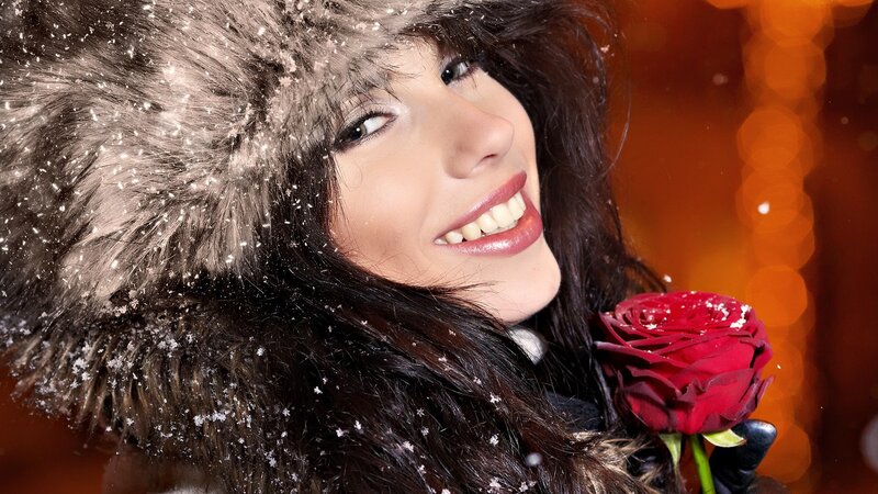woman with red rose in snow