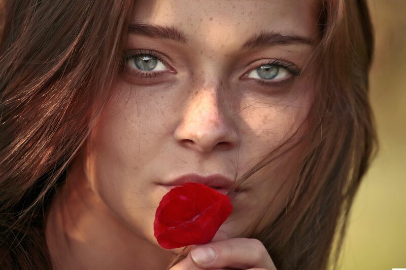 woman with red rose petal