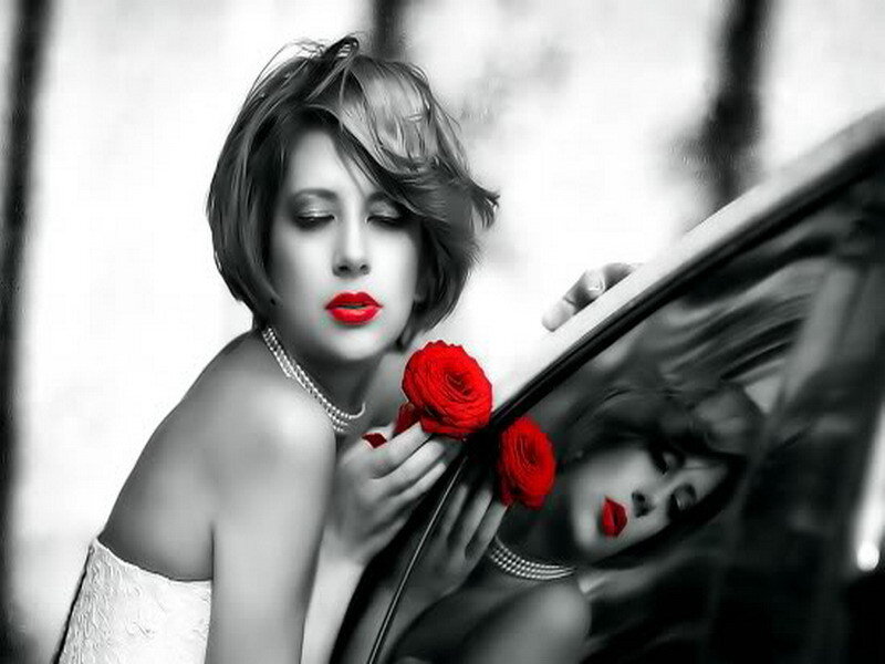 woman with red roses by car