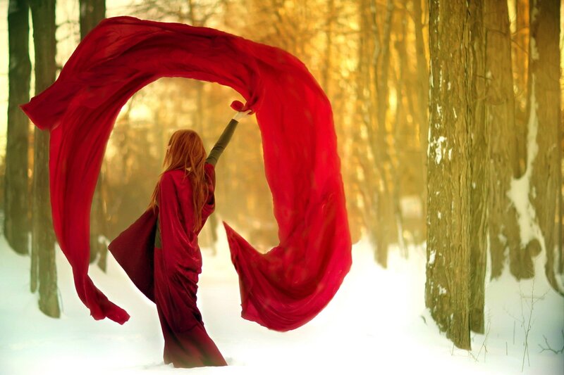woman with red scarf in winter forest