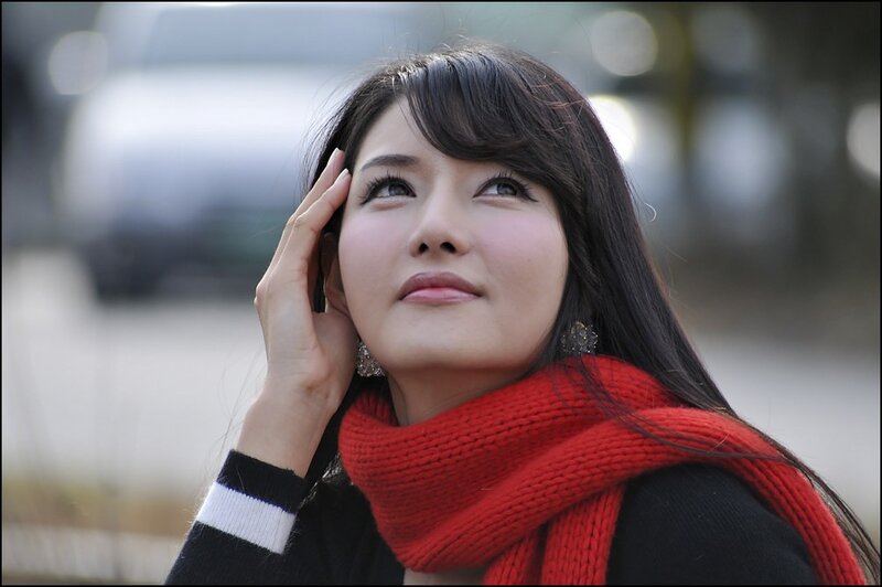woman with red scarf looking up