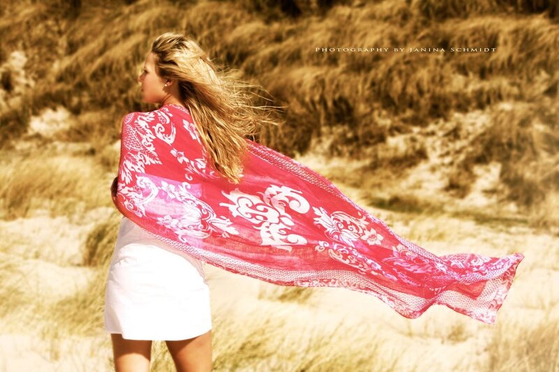 Woman with red scarf on beach