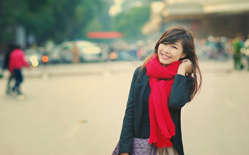 woman with red scarf smiling