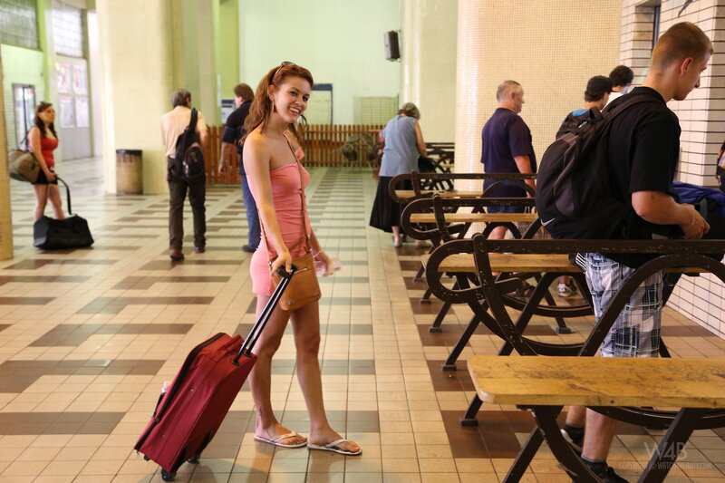 Woman with red suitcase in terminal