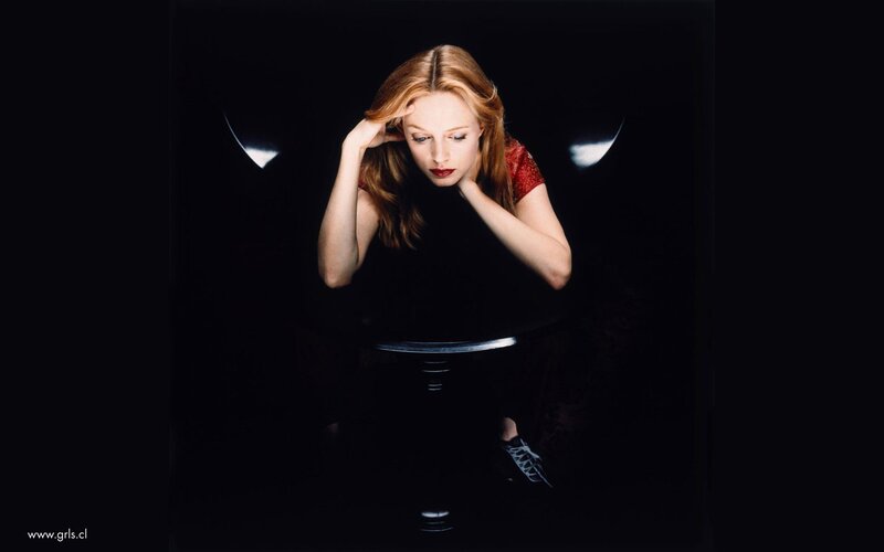 woman with red top in dark room